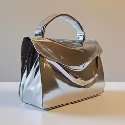 a silver handbag sitting on top of a table