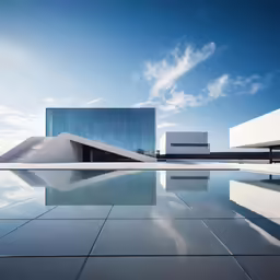 a building next to a lake near clouds