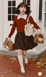 a woman walking down a sidewalk in a red sweater