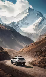 a van driving through mountains and dirt on a sunny day