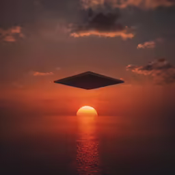an aerial view of the sun rising over the ocean