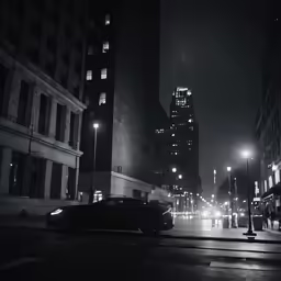 a car is driving down the street at night