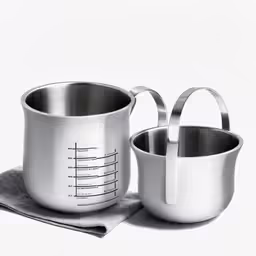 two silver pots sitting on top of a white background