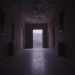 a room with a long row of windows on it and dark walls
