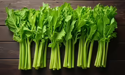 a bunch of greens laying on top of a wooden surface
