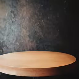 a round wood table stands against the background