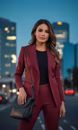 a woman is standing on the street in a red suit