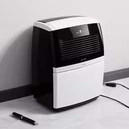 a white and black machine on the ground in a room