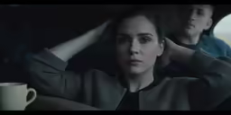 there is a woman sitting in front of a man