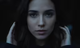 a woman with blue eyes looking directly into the camera