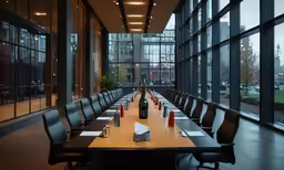 a long conference table with six chairs is empty