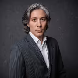 a male in a suit posing for a picture