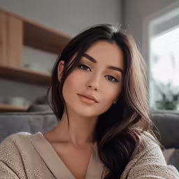 the woman is sitting on a couch looking into the distance