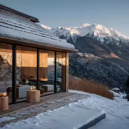 the outdoor living area of a resort overlooking mountains and trees