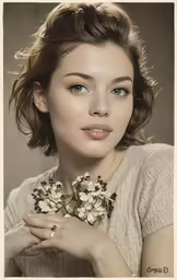 a young woman poses with flowers on her neck
