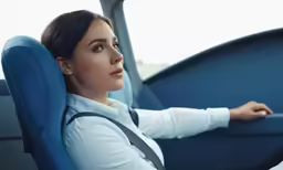 the woman is sitting in the back seat of the vehicle
