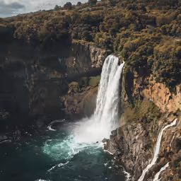 a waterfall in the mountains has a lot of water