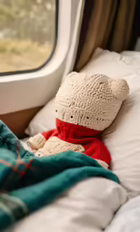 a stuffed bear that is laying on a bed