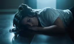 a very pretty woman laying on the floor