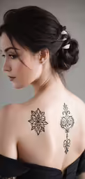 a woman in black is with a beautiful tattoo