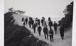 a group of people walking up a steep hill