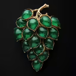 an antique carved green grapes brooch