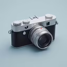 a silver camera on a blue surface with the lens showing