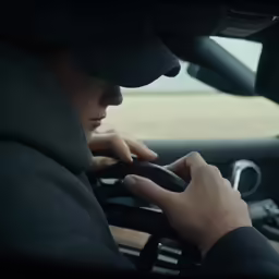 a person on a cell phone is sitting in a car
