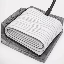 a stack of blankets and a radio antenna on a base