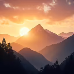the sun rises over mountains and trees in the foreground