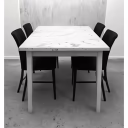a black and white photo of a table with a white marble top