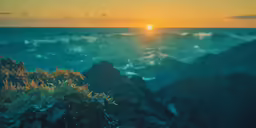 the sun is shining down over the mountains