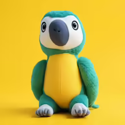 a stuffed bird sitting on top of a yellow background
