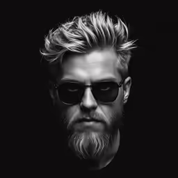 a man with a beard, wearing sunglasses and looking at the camera