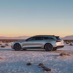 a silver car parked on top of a snow covered field