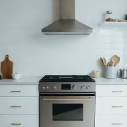 the kitchen has a stove and a silver oven