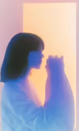 the silhouette of a woman and a cat against a yellow and purple background