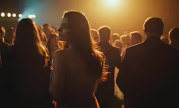 a woman in a dress walking past other people