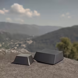 a pair of speakers sit on top of a rock