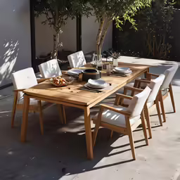 an outside table is covered with dishes and place settings