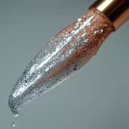 a liquid fountain with a golden tip