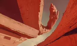a person is standing with their feet up in a narrow wall