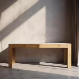 a bench in an empty room next to a window