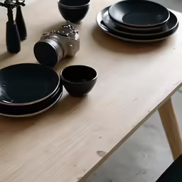 black plates and bowls are placed on the table