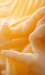 hands are holding an object in one hand and the other hand with something in the other