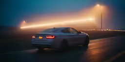 the rear end of a bmw car with fog and traffic