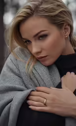 blond woman with large engagement ring looking at the camera
