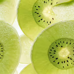 a closeup shot of several sliced kiwis