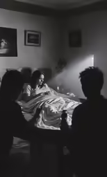 a young man laying in a bed with his mother