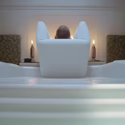 man sitting in an inflatable chair in a hotel room